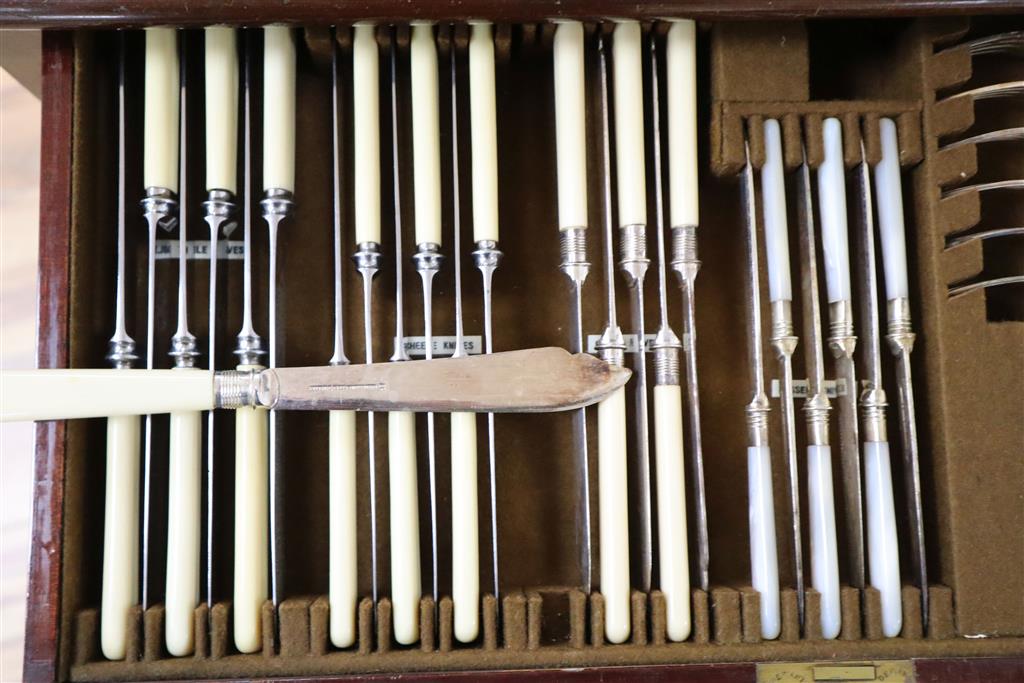 A Mappin & Webb part service of plated flatware in mahogany table canteen